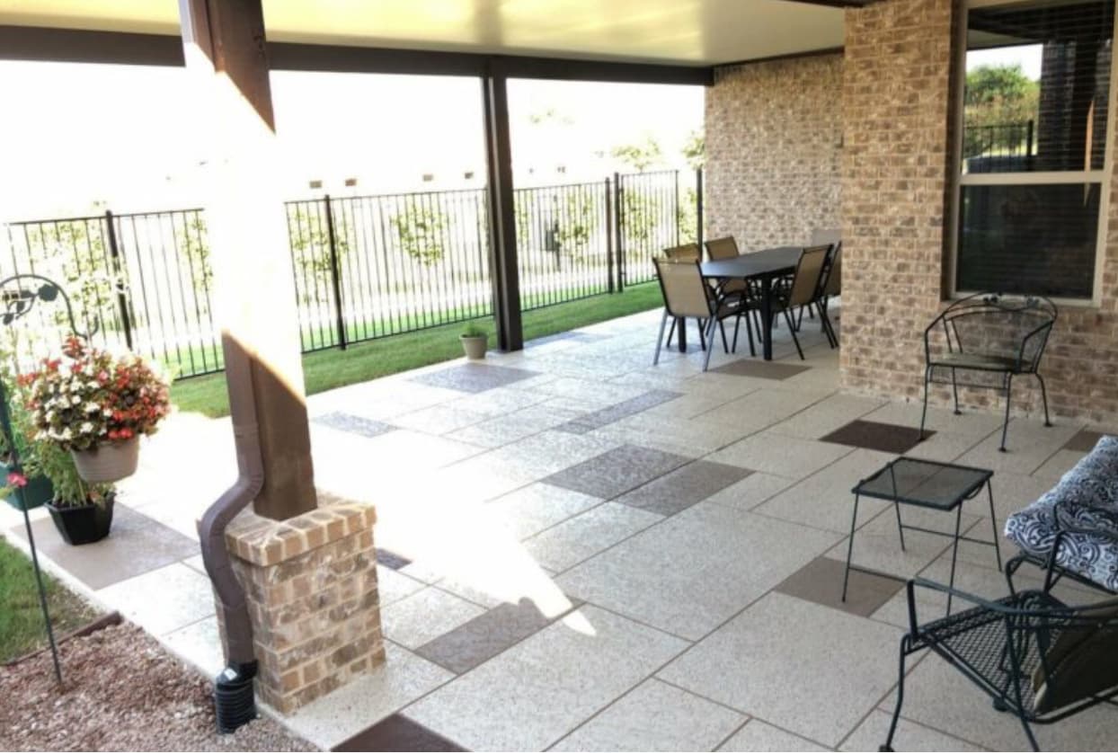 Decorative Sundek-coated patio with stamped pattern by Vivid Outdoor Living